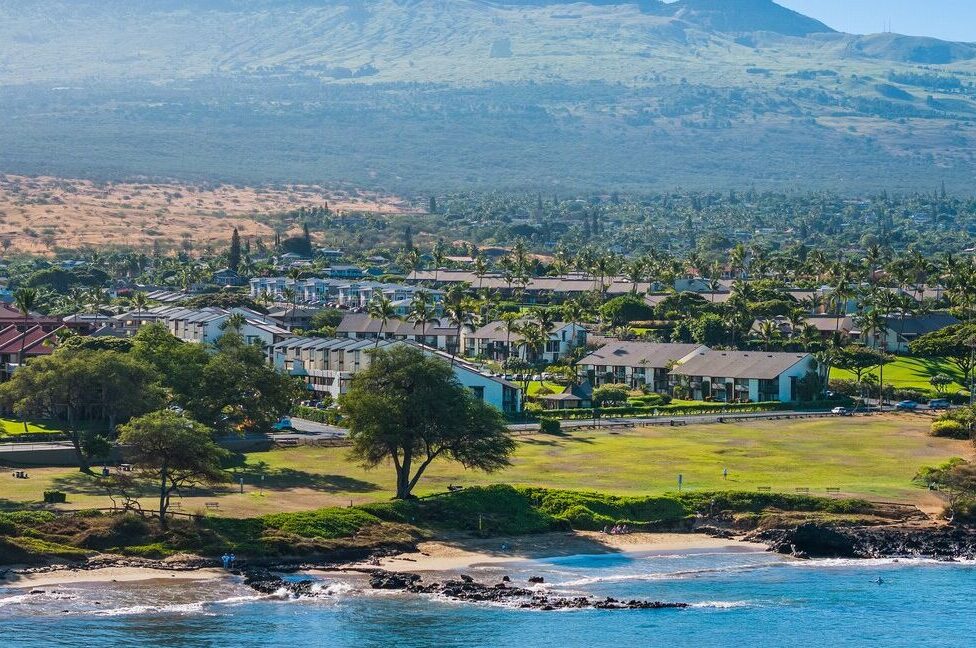 Aerial view of Hale Kamaole resort and properties with close proximity to the beach and mountains and greenery as its backdrop