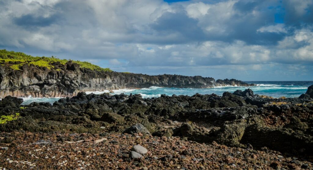 A rocky beach with waves crashing on the rocks at Waiʻānapanapa State Park