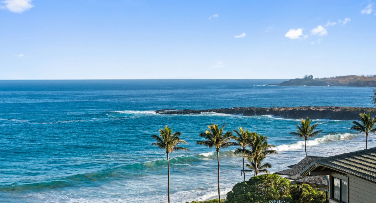Kapalua Bay aerial views of the blue ocean and palm trees on a bright sunny day 