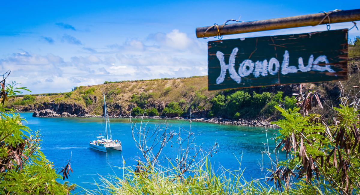 A catamaran anchored in Honolua Bay, Maui, on a calm September morning — a Marine Life Conservation District known for exceptional snorkeling visibility